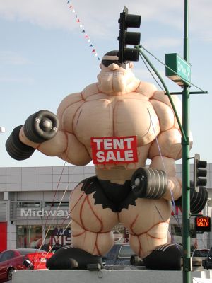 Giant muscle man sells Nissans.
