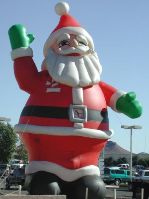 Giant Santa sells used trucks.
